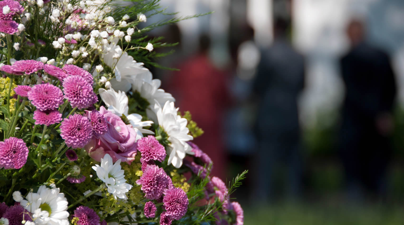 Primer pla d'un arranjament floral funerari amb crisantems, flors tradicionals de Tots Sants.